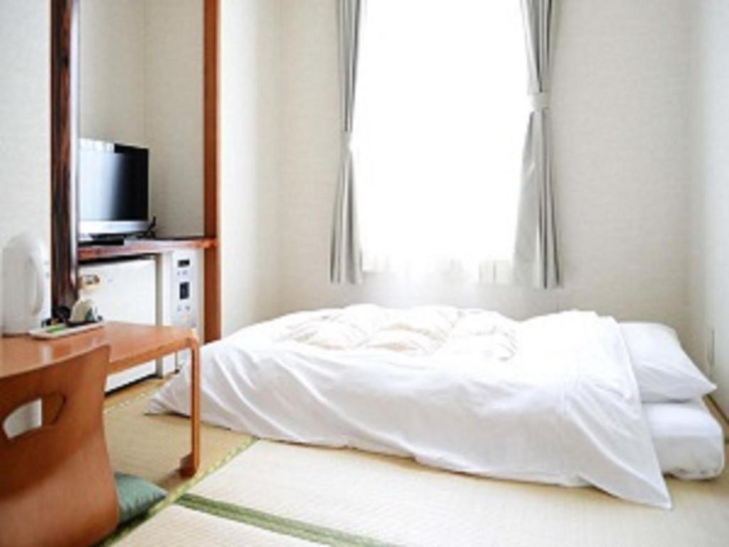 ホテル　港屋にあるベッド