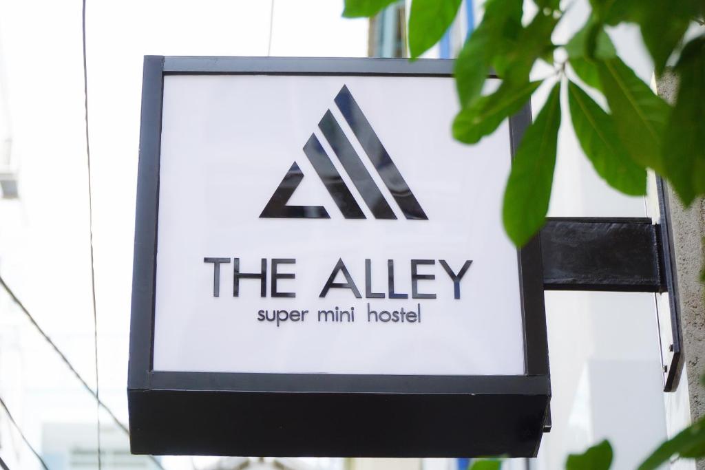 a sign for the alley super mini hotel at The Alley Hostel in Nha Trang