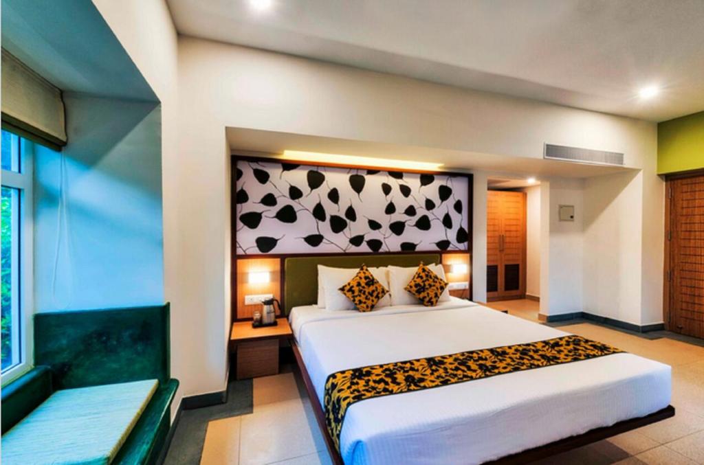 a bedroom with a bed with a leopard print headboard at Sterling Wayanad in Sultan Bathery