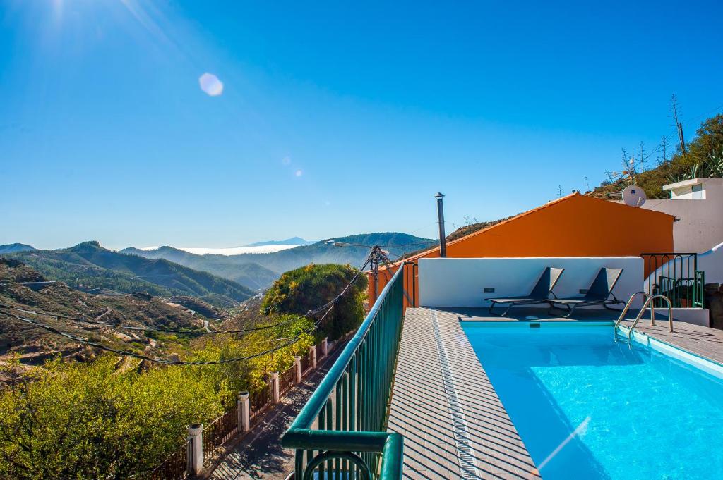 a villa with a swimming pool with a view at Casa Cueva Las Margaritas in Artenara