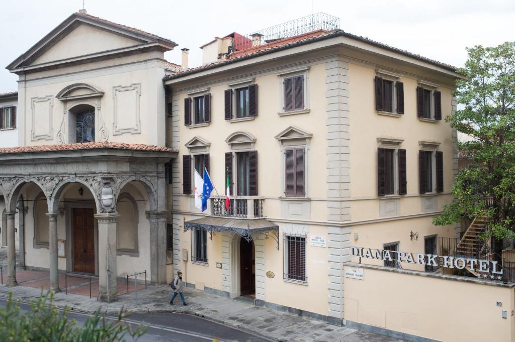 un hombre caminando delante de un edificio en Diana Park Hotel en Florence