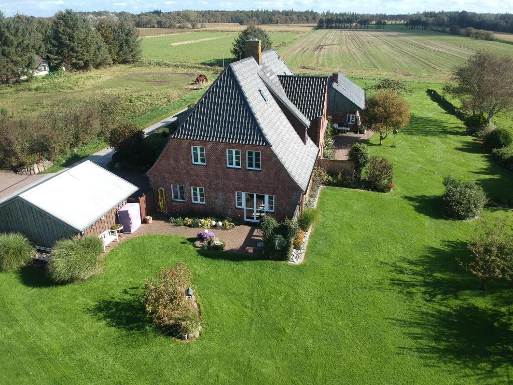 an aerial view of a house on a green field at Ferienhaus Addebüll in Langenhorn