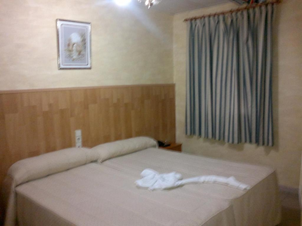 Posteľ alebo postele v izbe v ubytovaní Hostal Mays