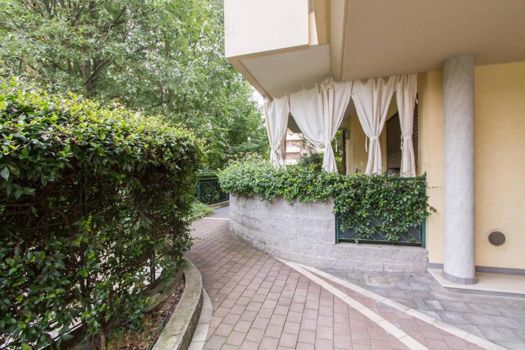 a building with a wall with curtains on it at Parco di Monza Apartment in Monza
