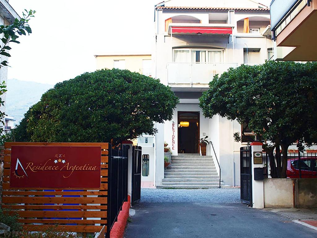 a building with a sign in front of it at Residence Argentina R.T.A. in Spotorno