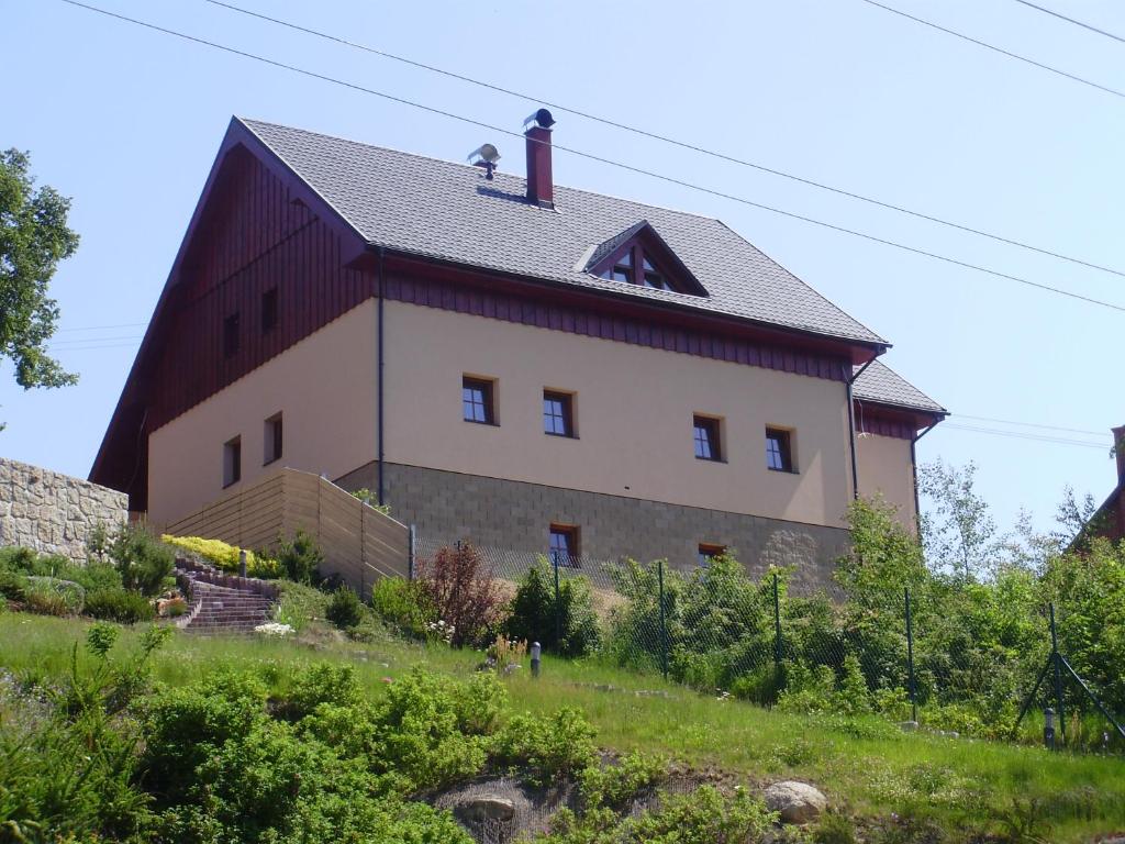 a large building with a red roof on a hill at Chata Albrechta in Albrechtice v Jizerských horách