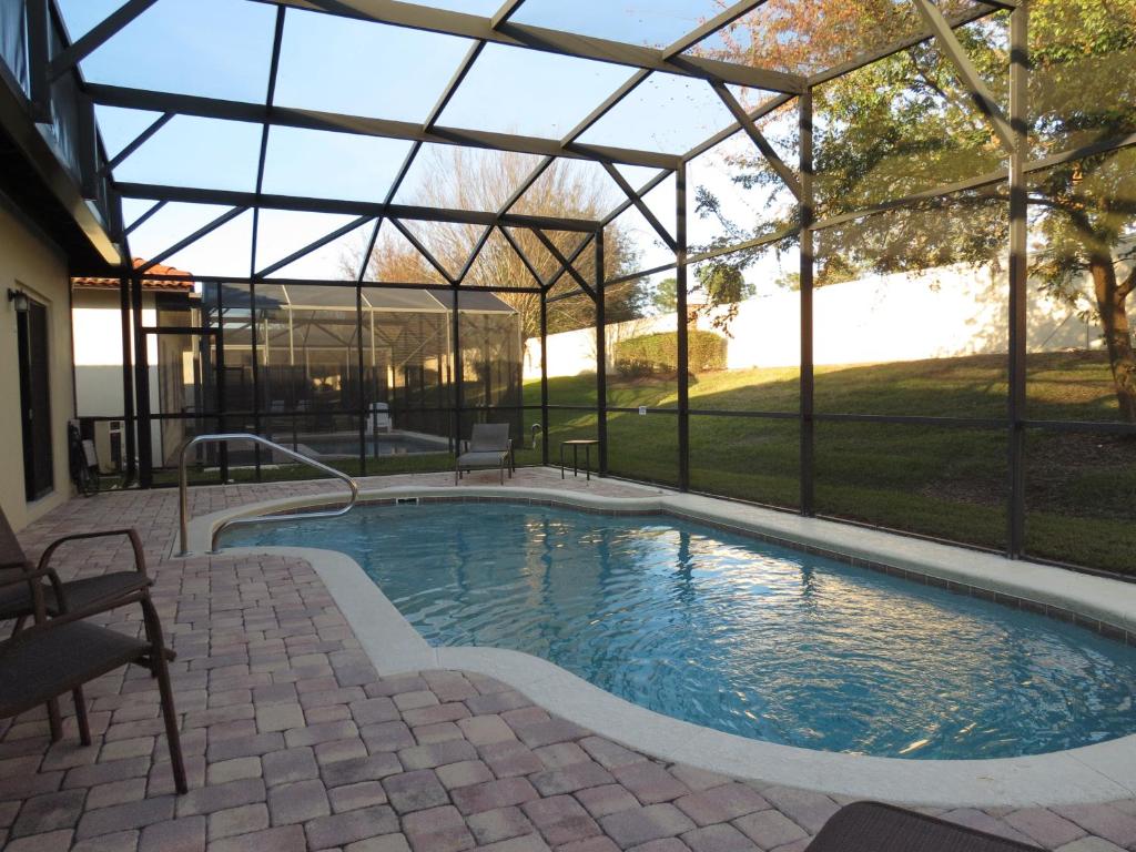 a swimming pool in a screened in house with a swimming poolvisor at Kissimmee Area Pool Home in Orlando