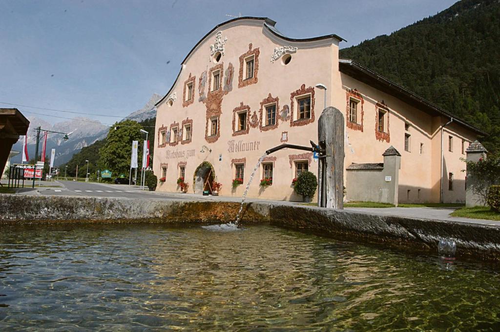 a building next to a river in front of a building at Mellauner Hof in Pettnau