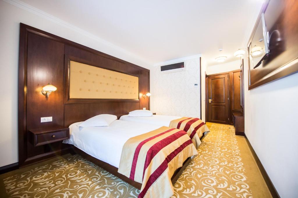 Postel nebo postele na pokoji v ubytování Hotel Silva Busteni