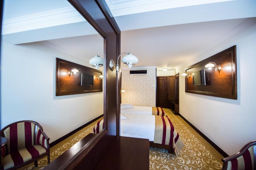 Postel nebo postele na pokoji v ubytování Hotel Silva Busteni