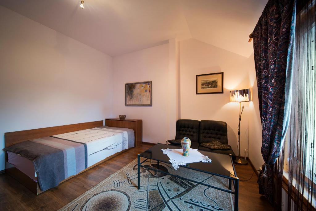 a hotel room with a bed and a table at Sunny Apartment Sofia in Sofia
