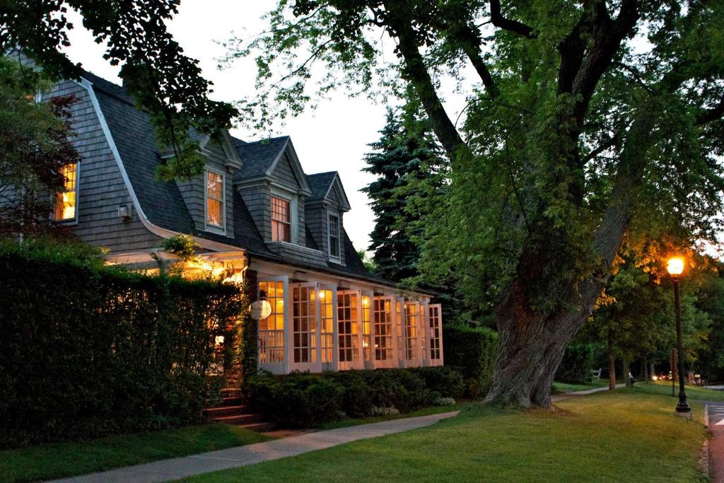 a house with christmas lights in front of it at Mill House Inn in East Hampton