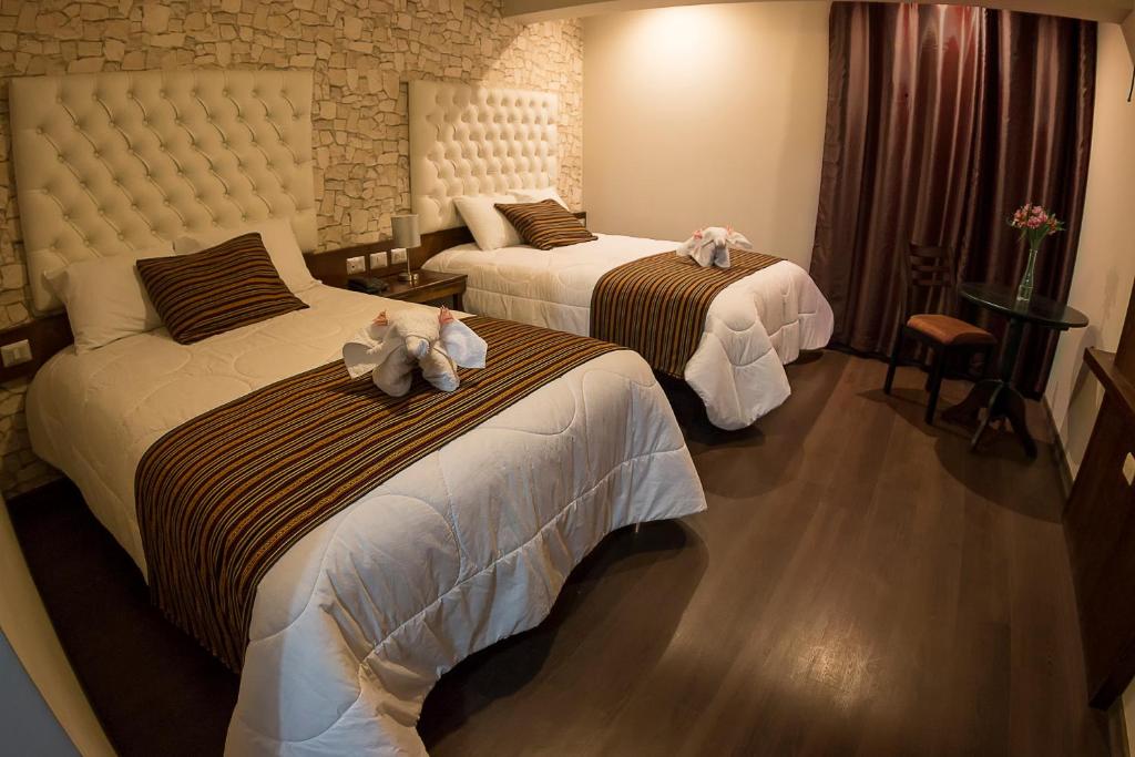 Katil atau katil-katil dalam bilik di Ureta Hotel