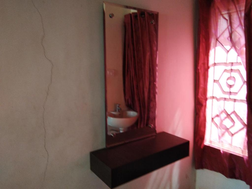 a bathroom with a sink and a mirror at Hotel John in Kanyakumari
