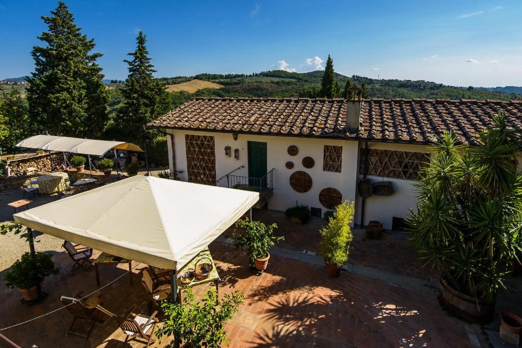 a white house with a tent in front of it at Agriturismo Olmi Grossi in Impruneta