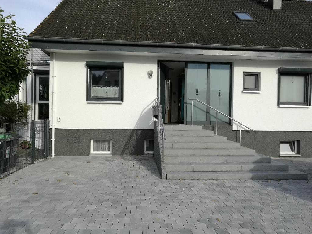 ein Haus mit einer Treppe, die zur Eingangstür führt in der Unterkunft Ferienwohnung in Neunkirchen