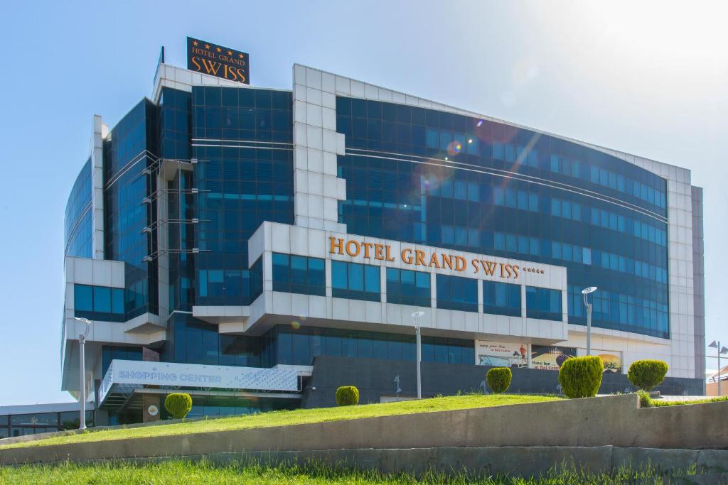 a building with a holt grand systems sign on it at Hotel Grand Swiss in Erbil