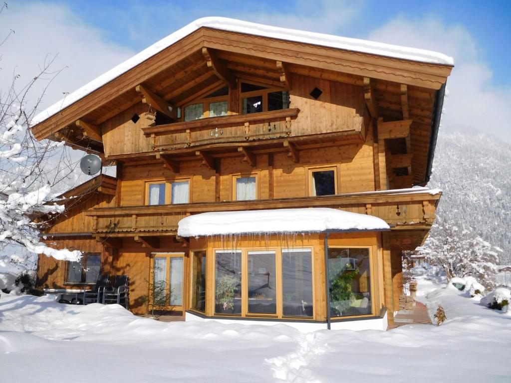 a log cabin in the snow at Apartment Aschaber in Waidring