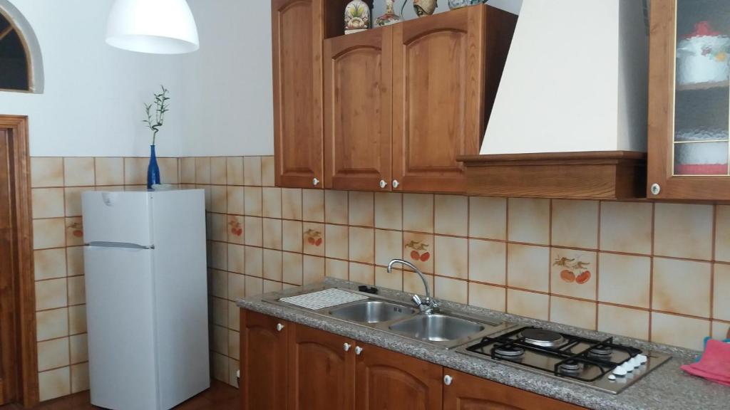 a kitchen with a sink and a refrigerator at Appartamento Isabella in Pistoia