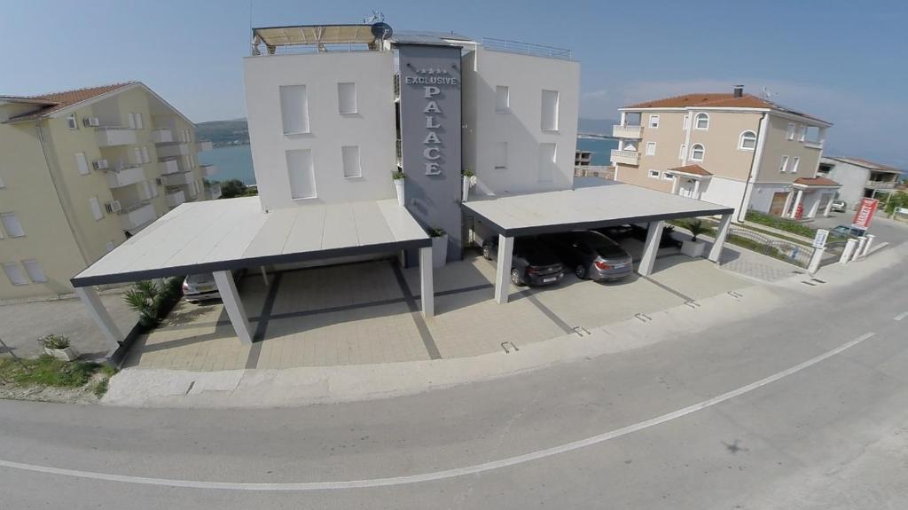 a bus stop with two benches on the side of a street at Apartments Exclusive Palace in Trogir