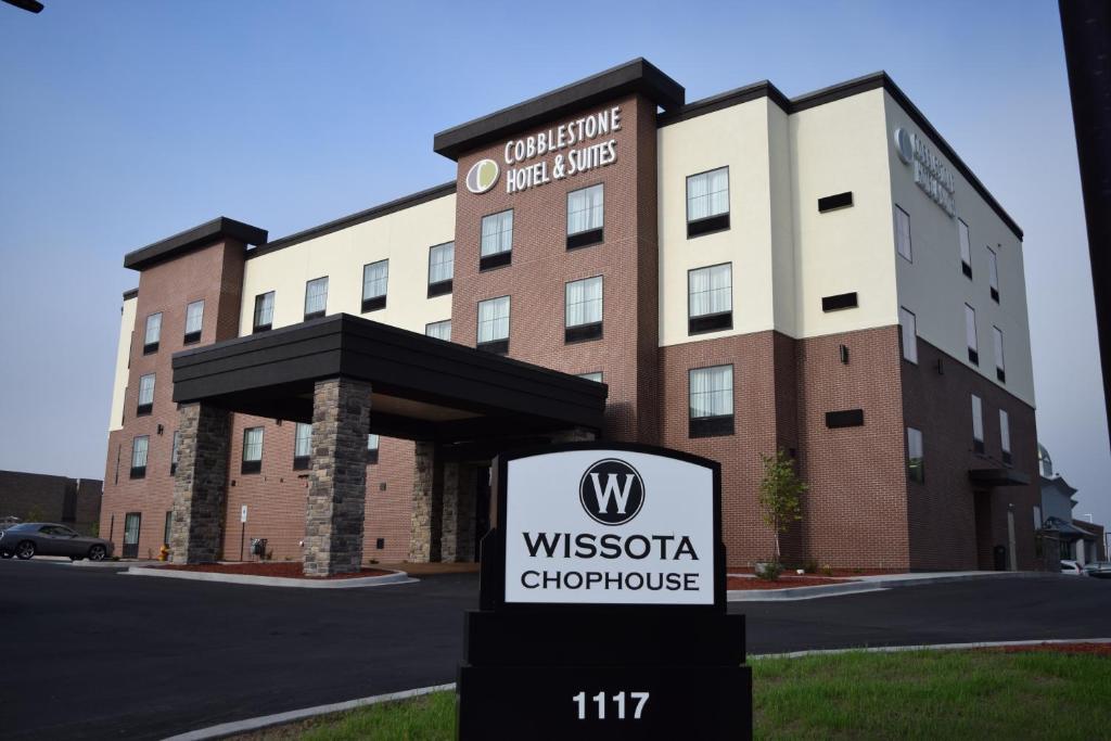 a sign in front of a wyssoria chicago hotel at Cobblestone Hotel & Suites - Stevens Point in Stevens Point