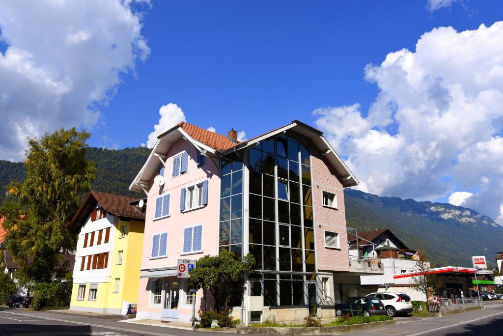 a building with a lot of windows on a street at City Center Holiday Apartment in Interlaken