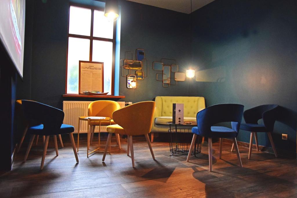 a dining room with chairs and a table and a window at L'Hôtel des Bords de L'ill in Erstein