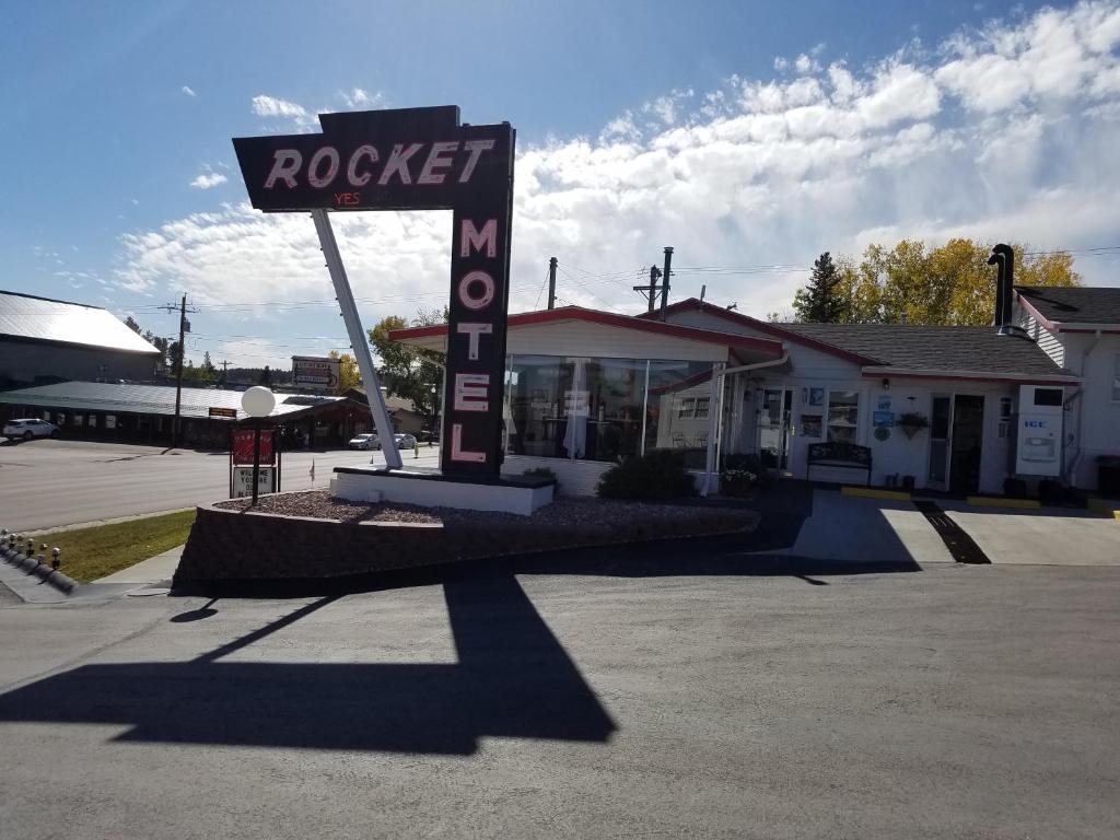 a sign for a rockett motel in a parking lot at Rocket Motel in Custer