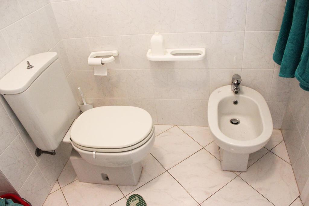 a bathroom with a toilet and a bidet at Lagomare Puccini in Torre del Lago Puccini