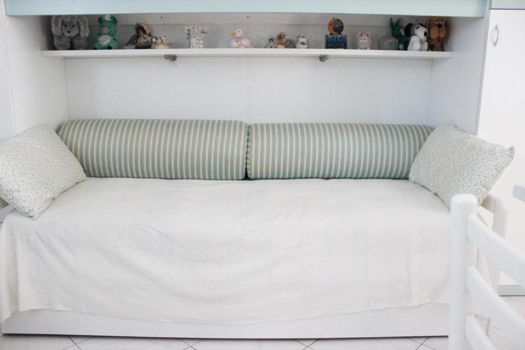 a couch with two pillows in a room at Lagomare Puccini in Torre del Lago Puccini