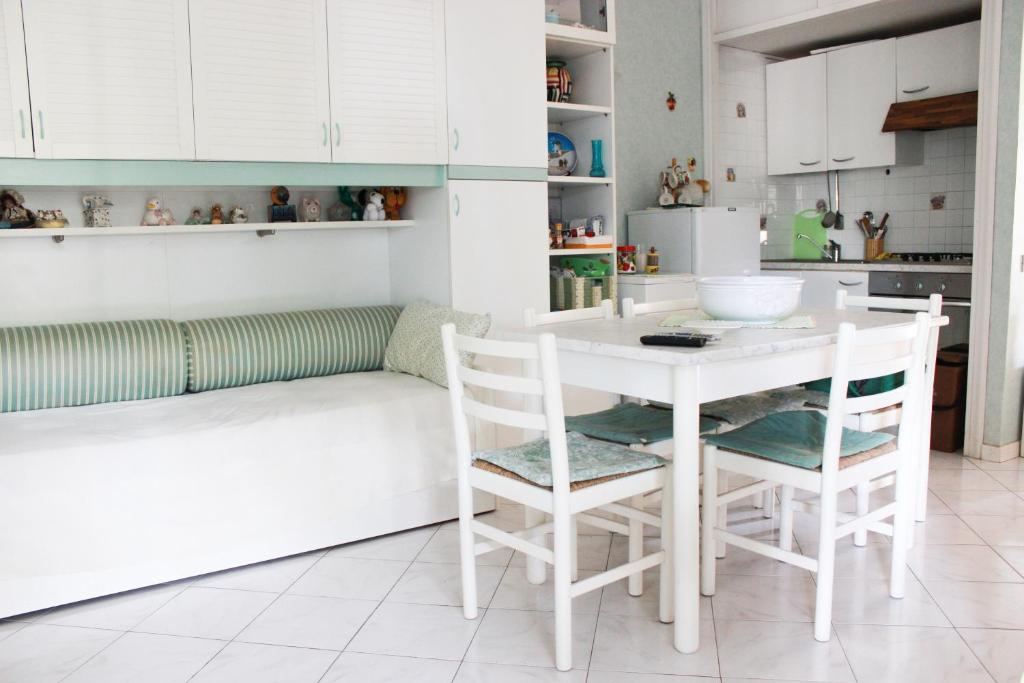 a kitchen with a white table and chairs at Lagomare Puccini in Torre del Lago Puccini