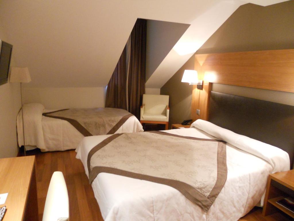 Postel nebo postele na pokoji v ubytování Alti Hôtel