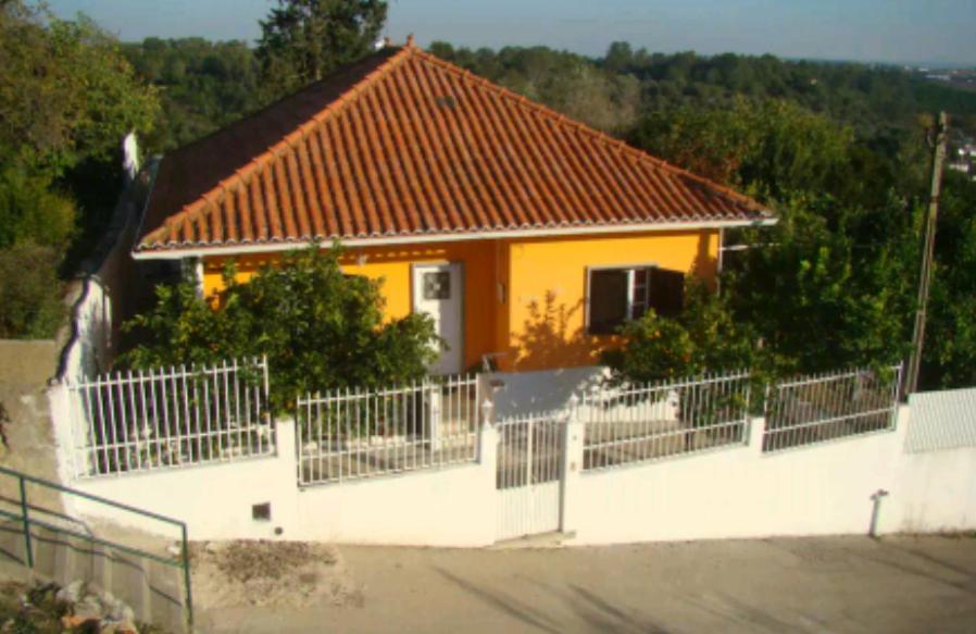 a house with a white fence in front of it at Vivenda tilia in Pernes
