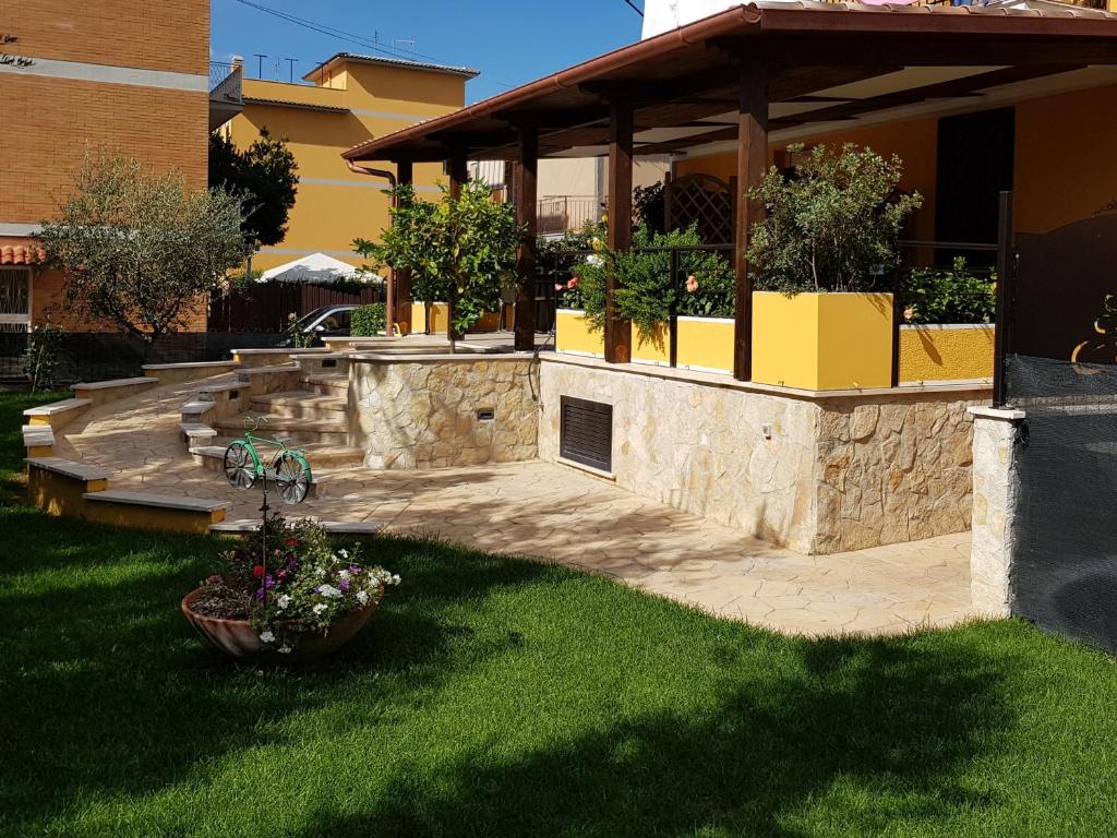 a house with a patio and a porch with plants at 4 Rent di Cicchinelli Lorella in Albano Laziale