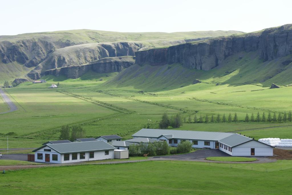 a small town with houses and a mountain range at Adventure Hotel Geirland in Kirkjubæjarklaustur