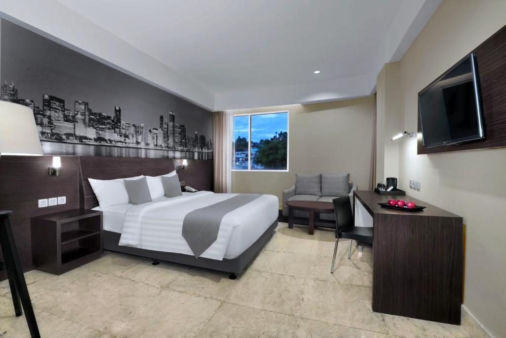 Postel nebo postele na pokoji v ubytování Hotel Neo+ Balikpapan by ASTON