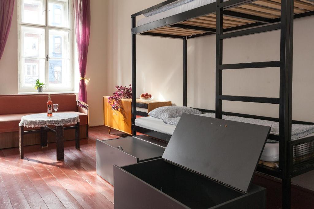 
a room with a bed and a desk with a laptop on it at Hostel Fleda in Brno
