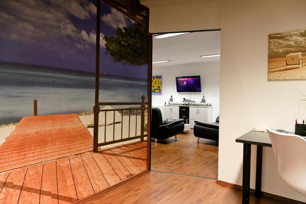 a living room and dining room with a sliding glass door at Suite-Apartment-Essen in Essen