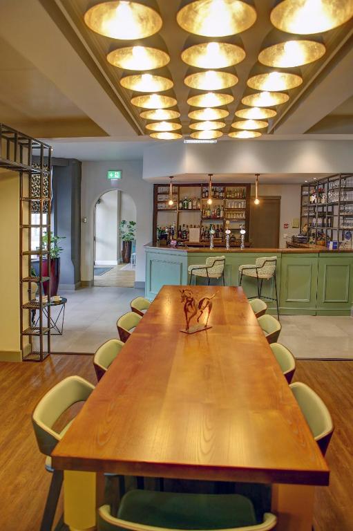 a conference room with a wooden table and chairs at Best Western Plus Nottingham Westminster Hotel in Nottingham