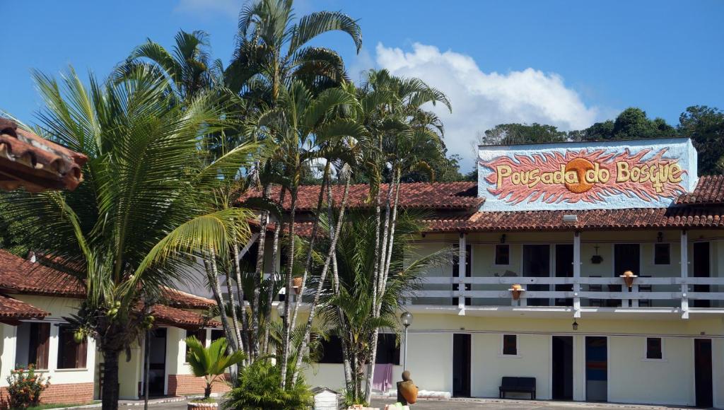 a building with a sign on the side of it at Pousada Do Bosque in Itajuípe