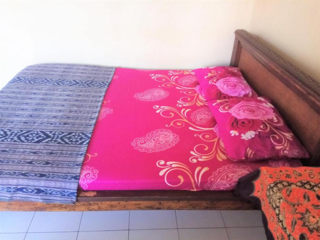 Postel nebo postele na pokoji v ubytování Arjuna Homestay Ubud