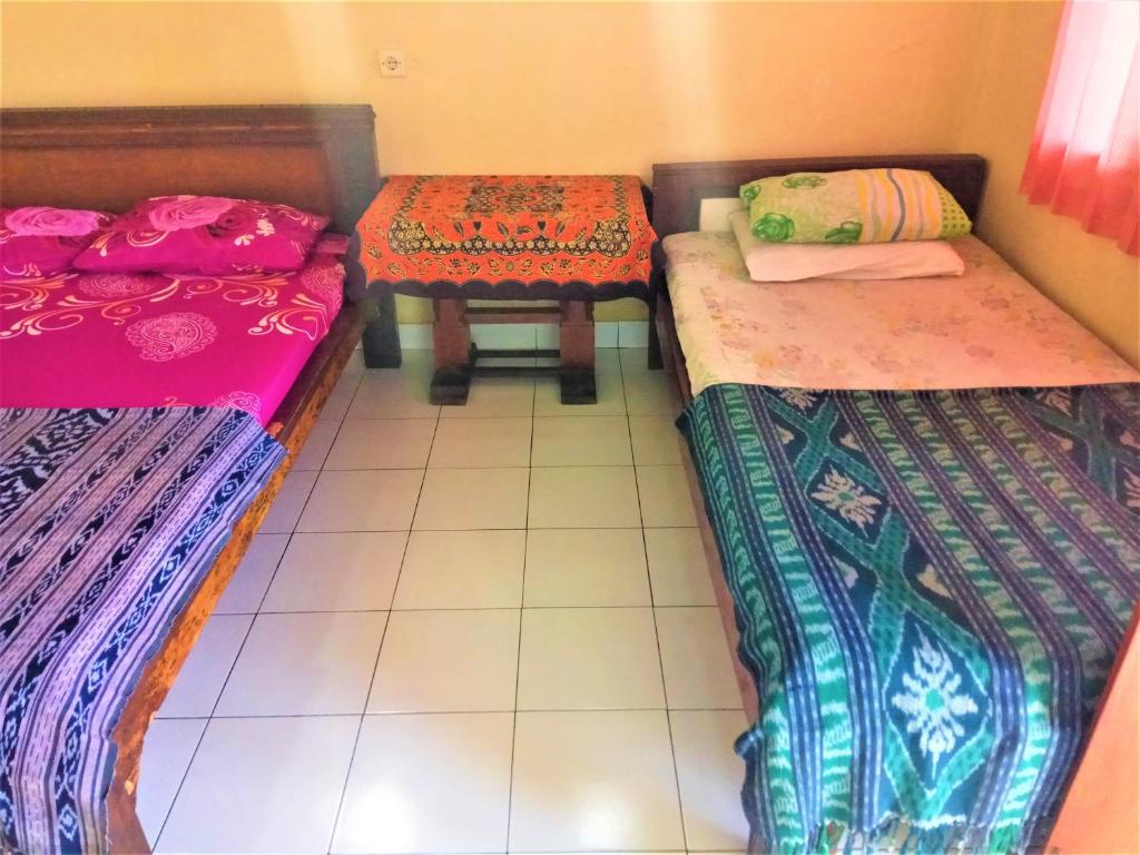 Postel nebo postele na pokoji v ubytování Arjuna Homestay Ubud