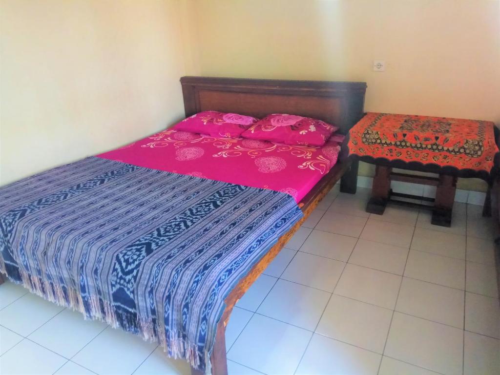 Postel nebo postele na pokoji v ubytování Arjuna Homestay Ubud
