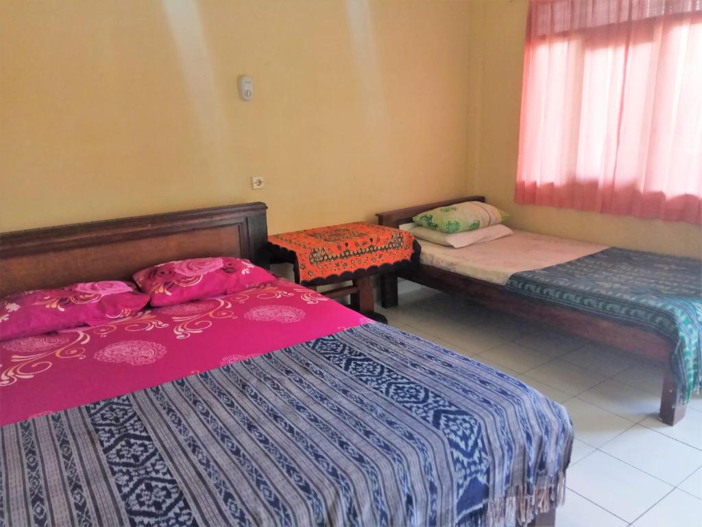 Postel nebo postele na pokoji v ubytování Arjuna Homestay Ubud