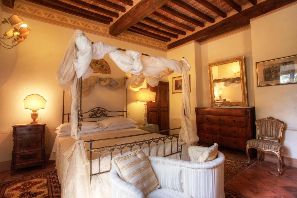 Postel nebo postele na pokoji v ubytování Relais Villa Baldelli