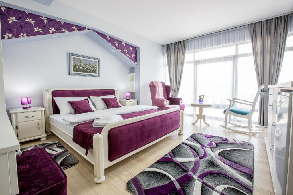 a bedroom with a purple bed and a purple rug at Apartmani MG in Nikšić