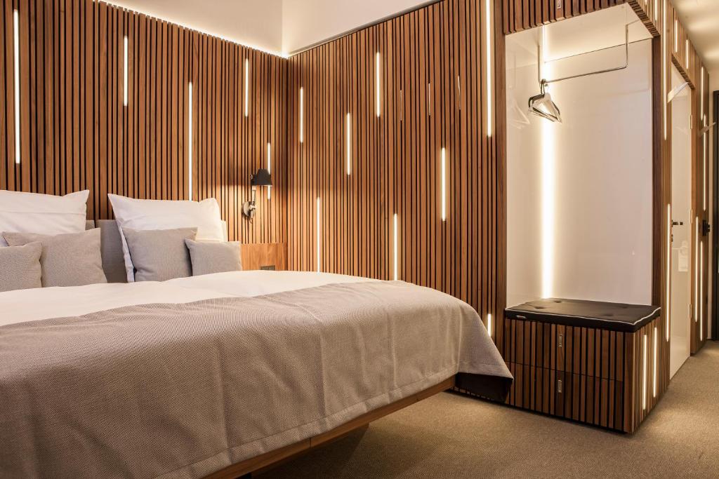 a bedroom with a large bed and a television at H24 Berlin Lichtenberg in Berlin