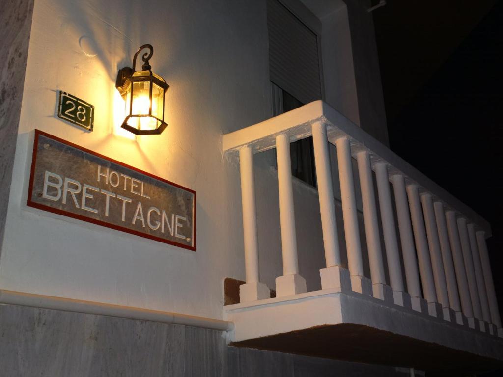 a sign on the side of a building with a hotel heritage sign at Hotel Bretagne in Loutraki