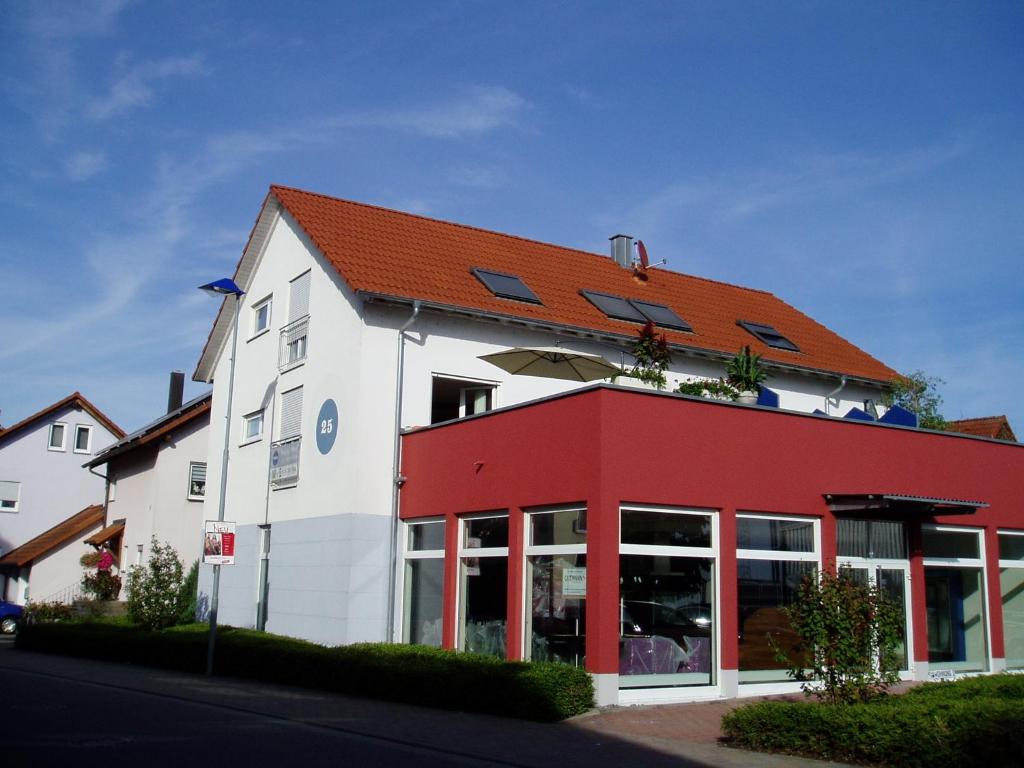 a red and white building with a red roof at Apartment Carmen in Rust