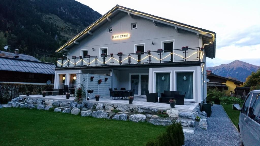 a white house with a balcony on top of it at Chalet Taube in Bad Gastein